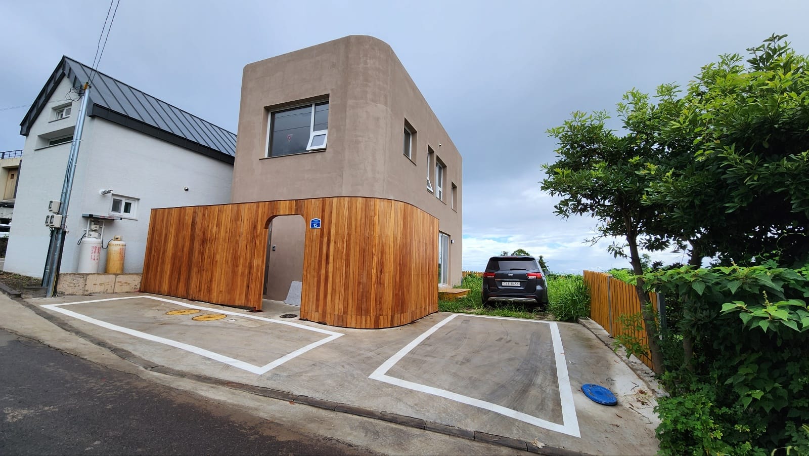 The finished exterior with fresh parking lines and the house number 15